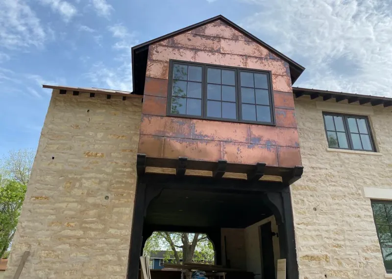Copper metal panel facade on a stone building for Skylight Installation in West Puente Valley